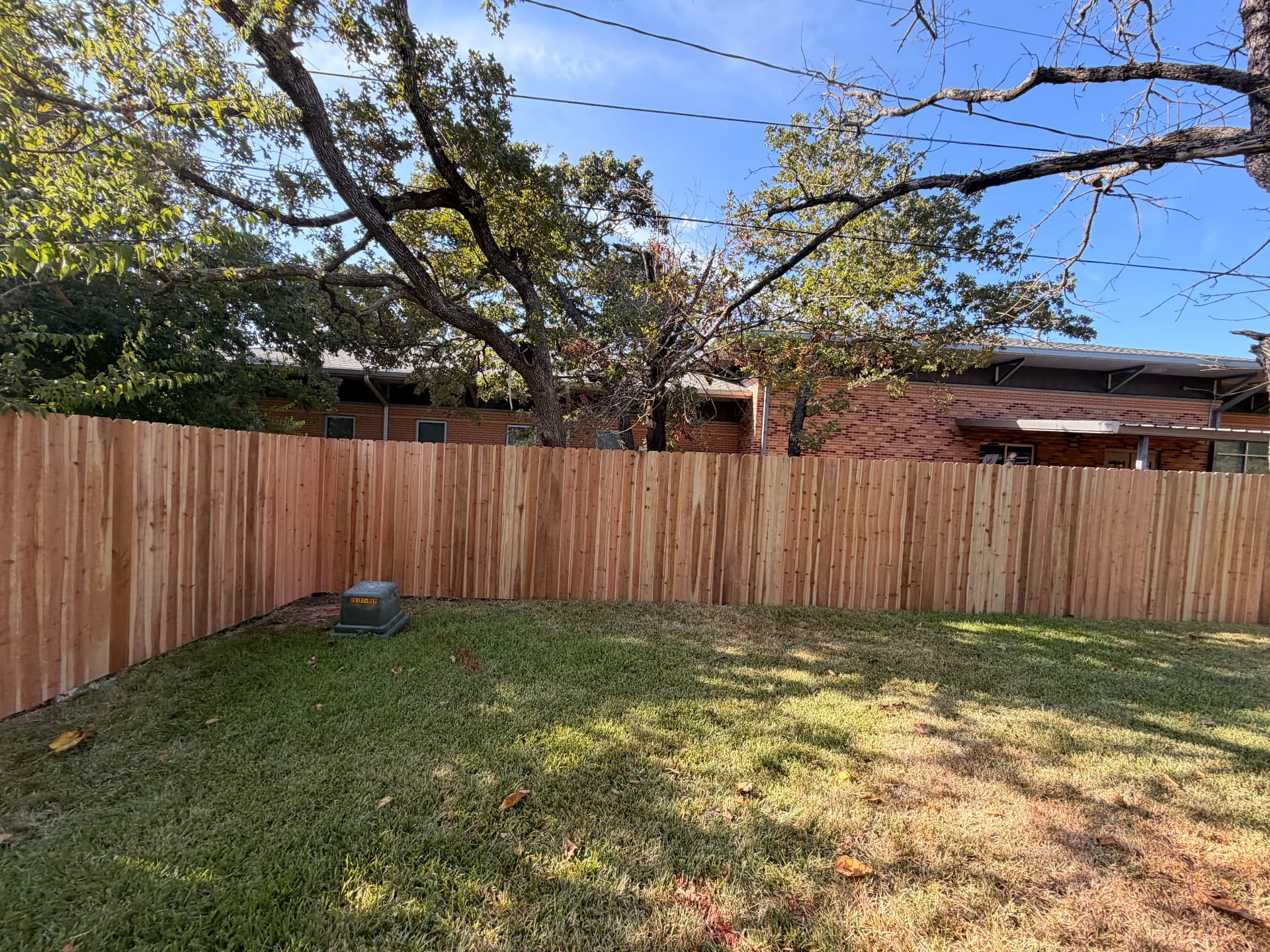 Dog-ear cedar privacy fence enclosing a Bryan TX backyard